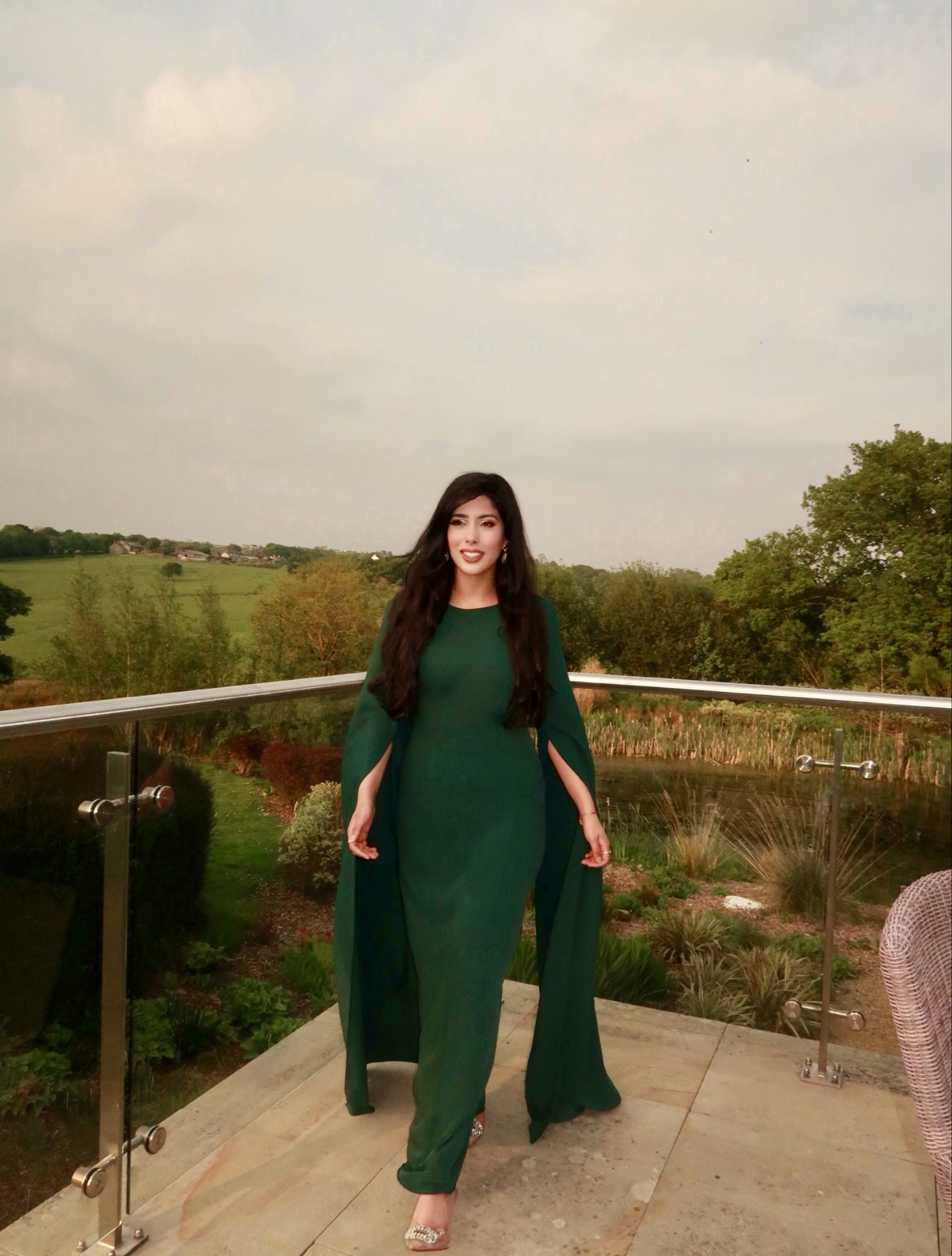Tasleema Kola, founder of Focus Ladder, smiling outdoors in a green outfit
